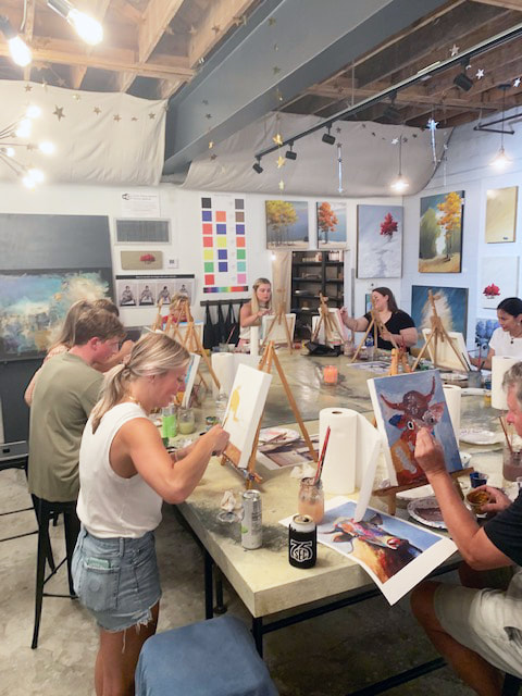Paint supplies and canvases on studio tables